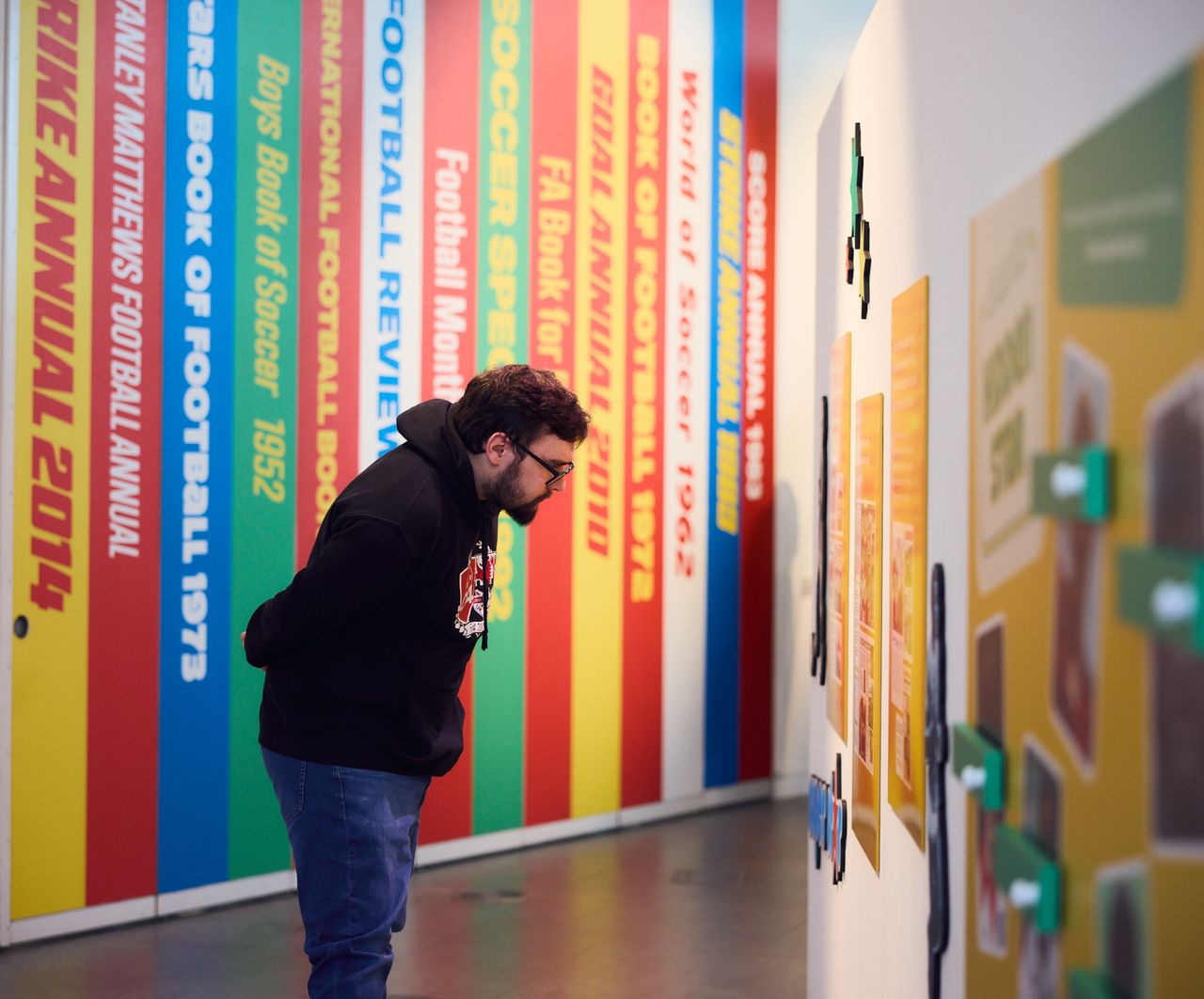 Visitor exploring the Football Annual exhibition