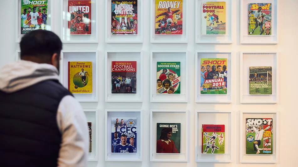 A wall of displayed football annuals